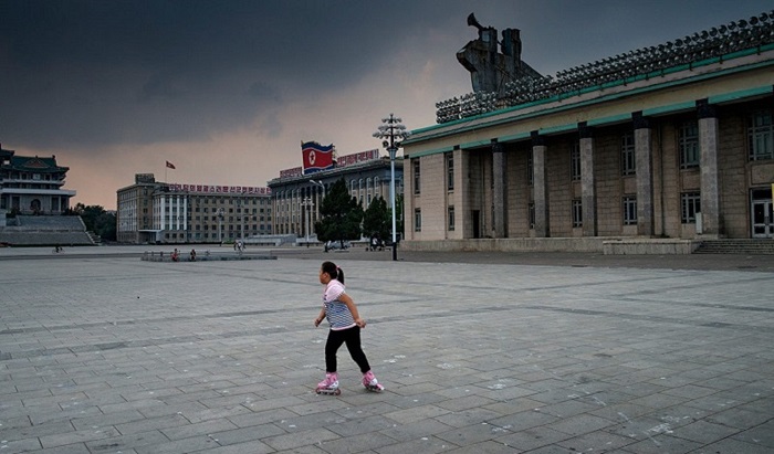 A skater makes her way across a busy tourist site